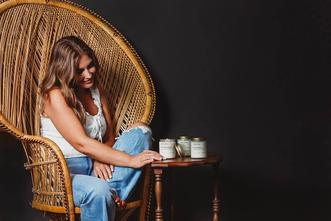 Woman sitting in a wicker chair with a dark background